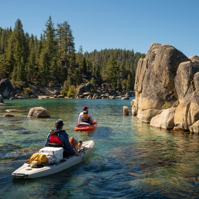 a group of people riding on clear kayak on Lake Tahoe