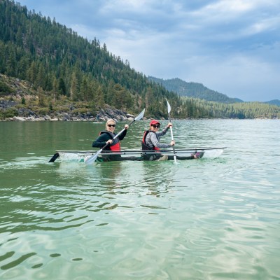 a group of people rowing a boat in a body of water
