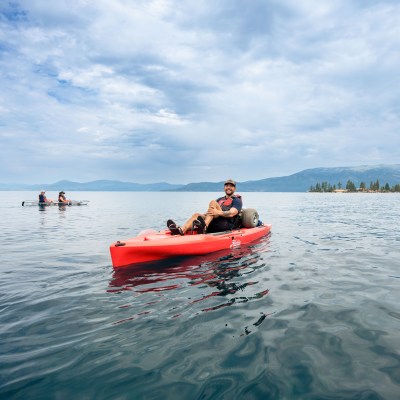 a group of people in a small boat in a body of water