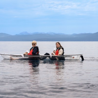 a group of people rowing a boat in a body of water